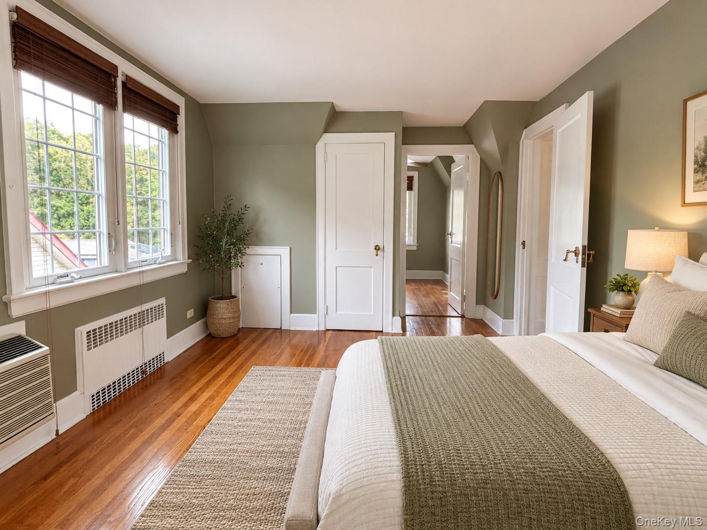 Hardwood flooring, multi-pane windows with integrated blinds, and solid-core interior doors with brass hardware