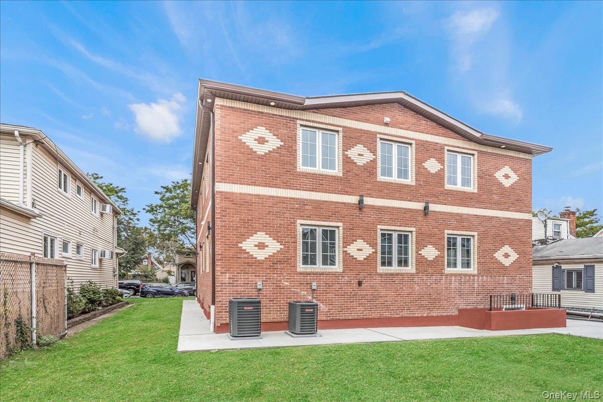 Back of house with brick siding and a patio
