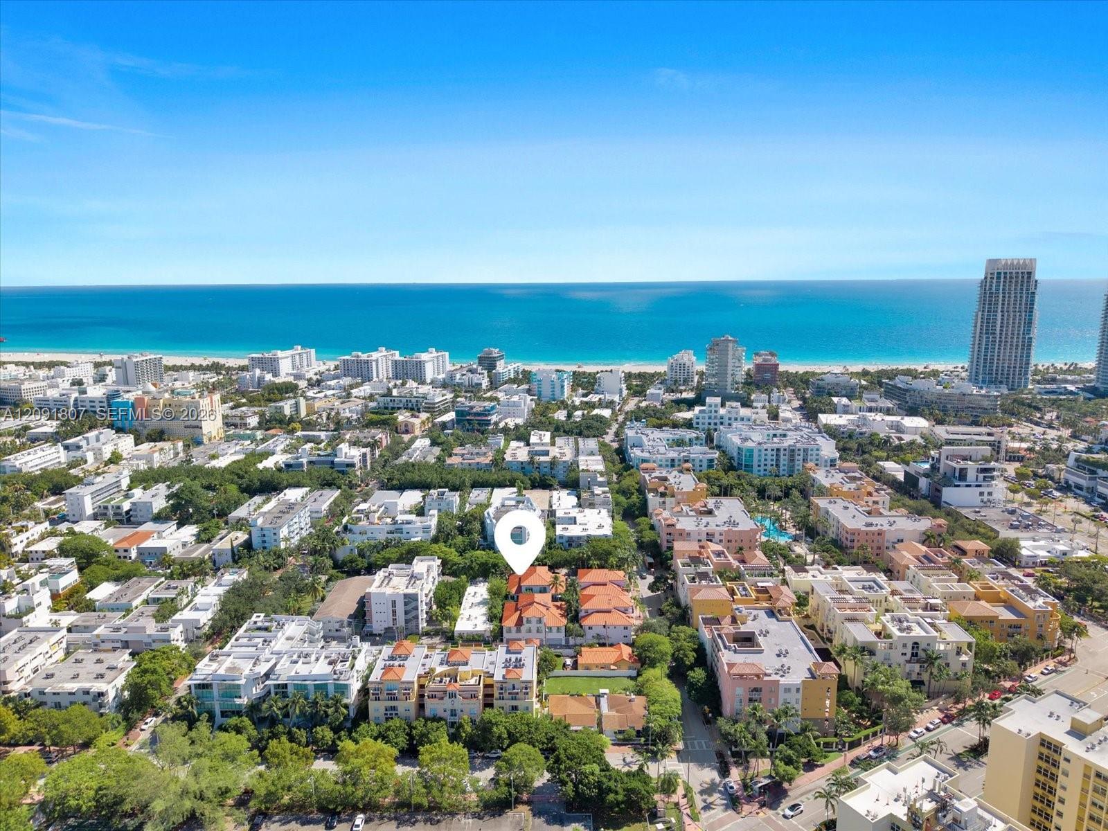 Aerial perspective featuring terracotta-tiled rooflines and proximity to the coastline