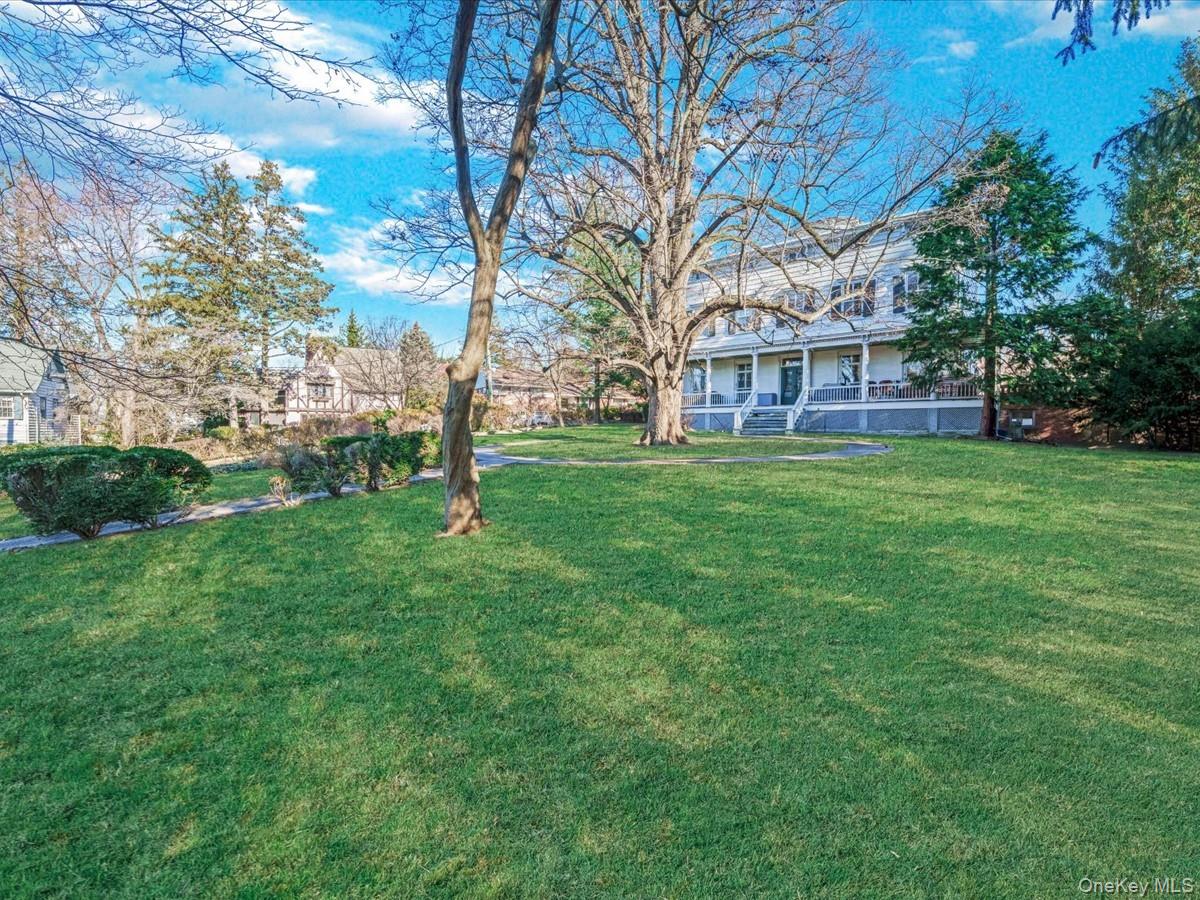 View of green lawn with a porch