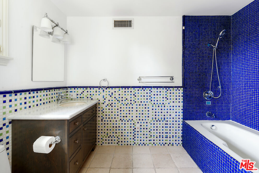 bath adjacent green bedroom