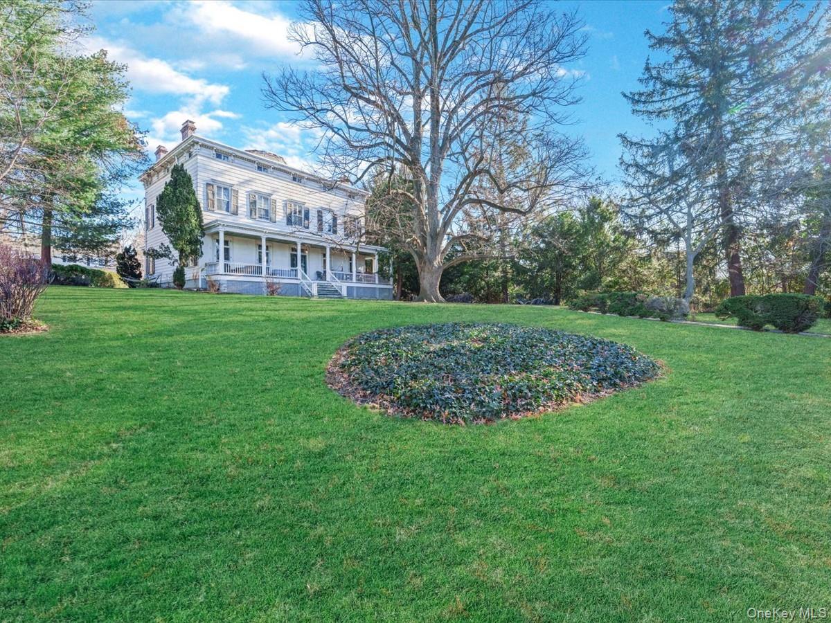 View of green lawn with covered porch