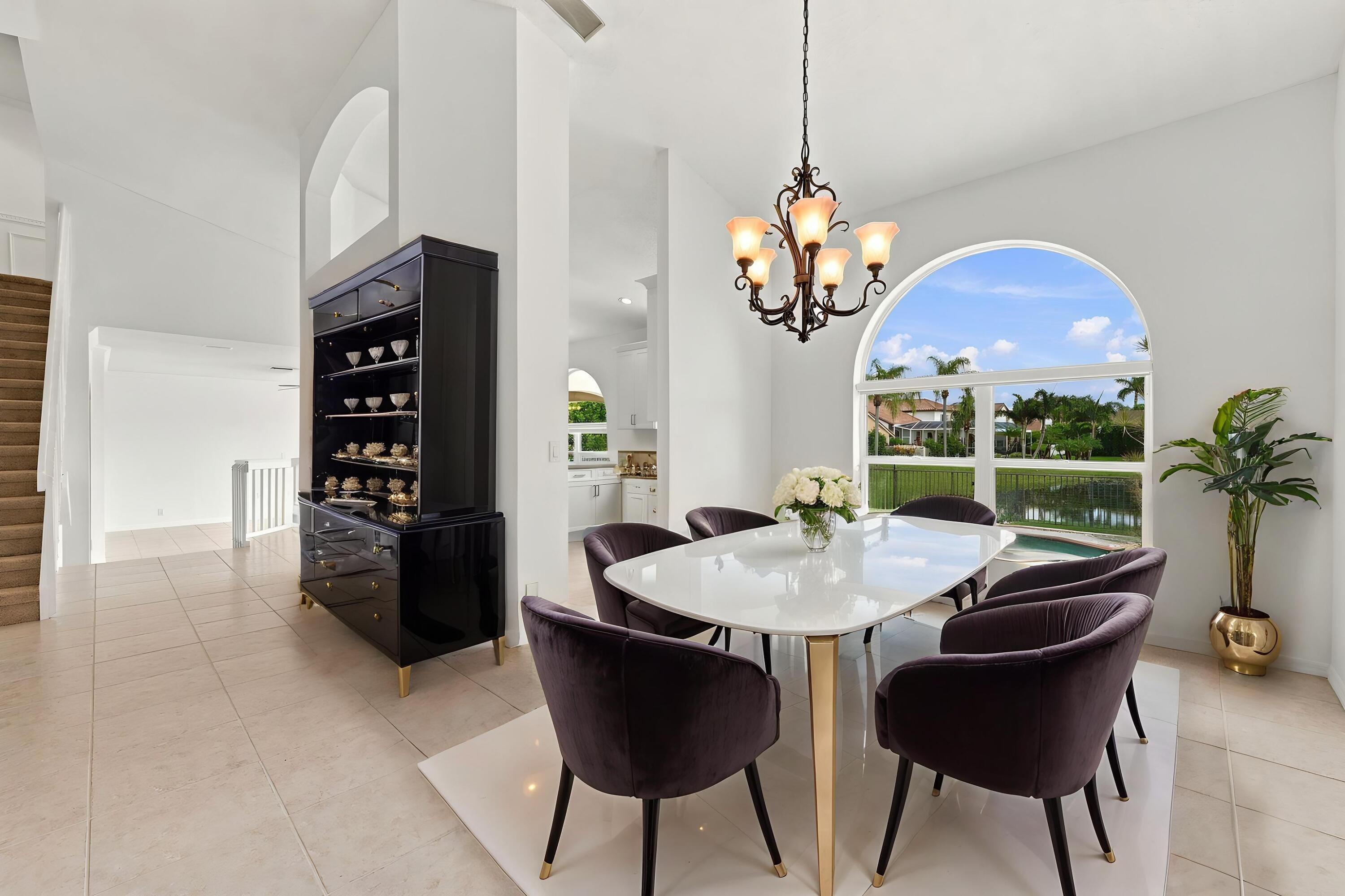 An elegant chandelier, soaring ceilings, and an open connection to the adjacent living areas create a wonderful setting for entertaining.