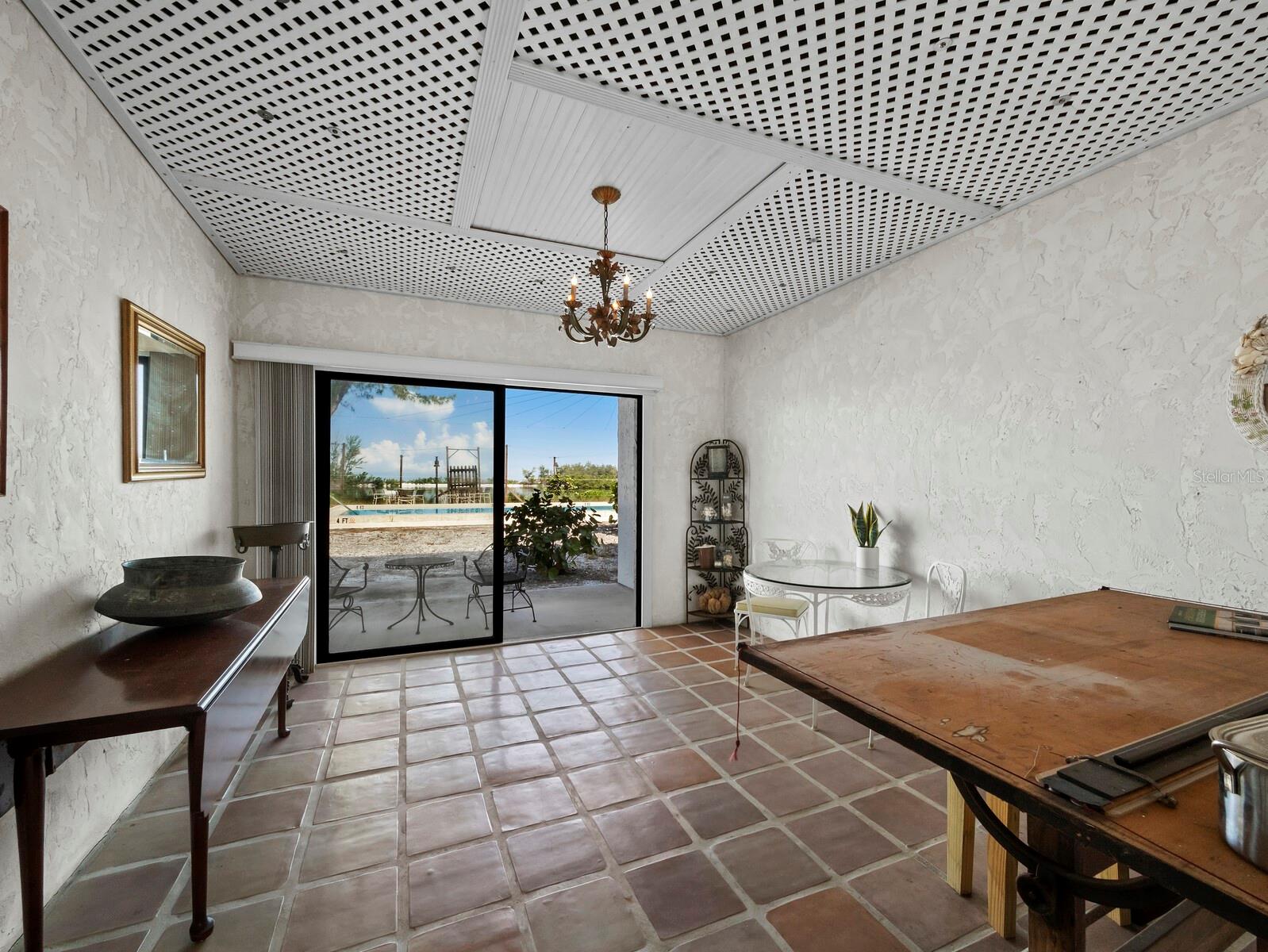 The ground level bonus room with sliders to the pool