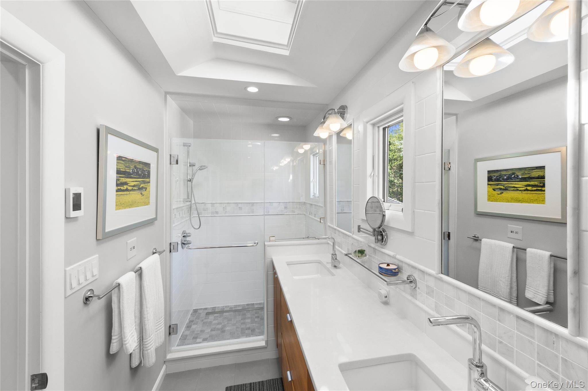 Sun filled renovated primary bathroom with beautiful finishes and many special features