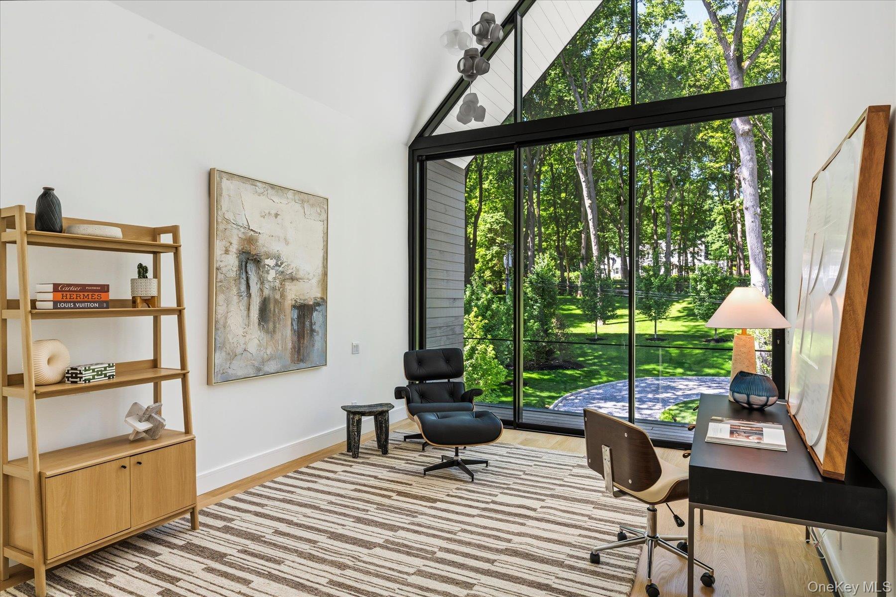 Second floor bedroom with floor to ceiling windows and outdoor access to balcony with water views