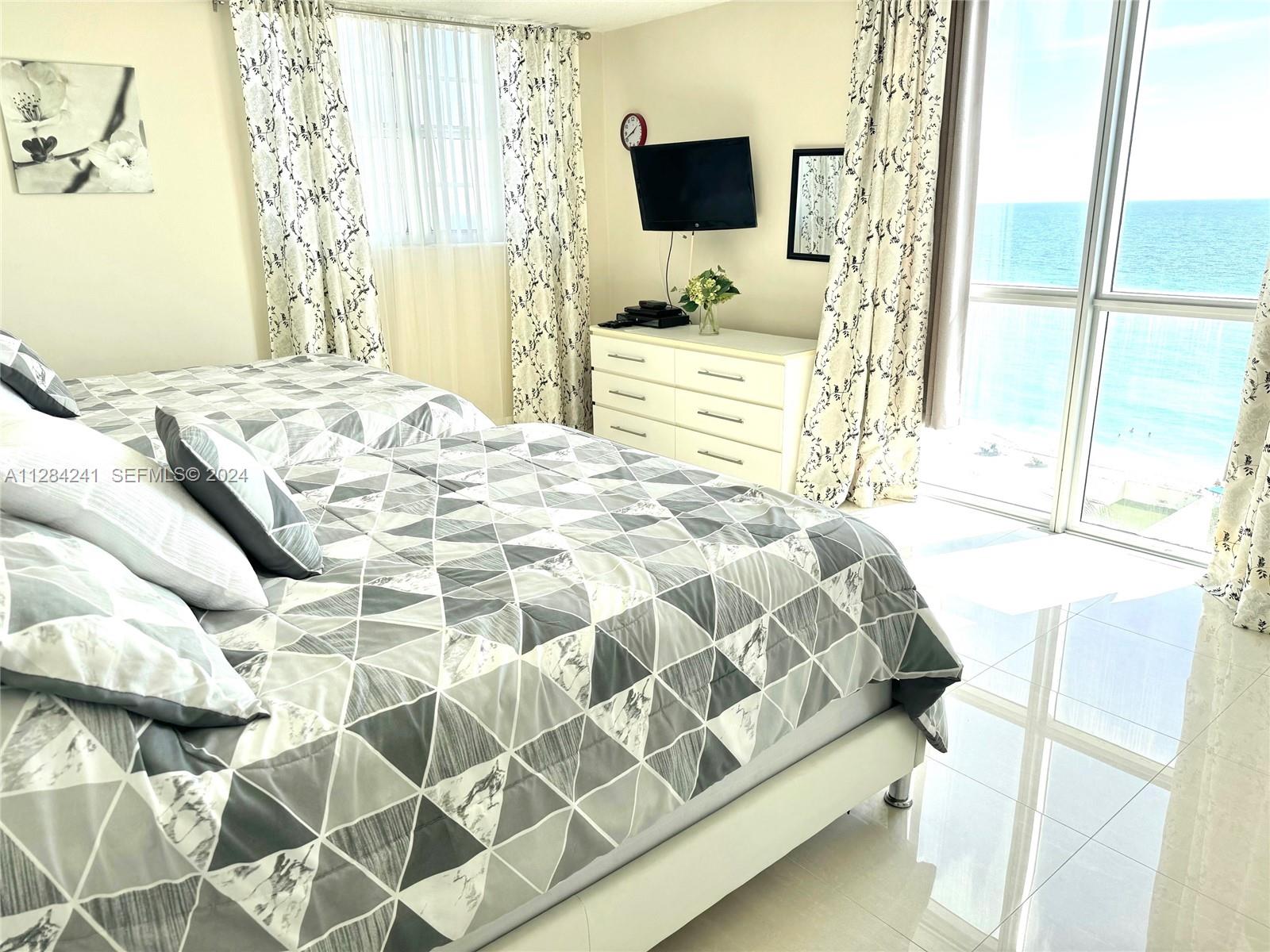 Main bedroom with Direct east ocean/beach view. 2 queen beds