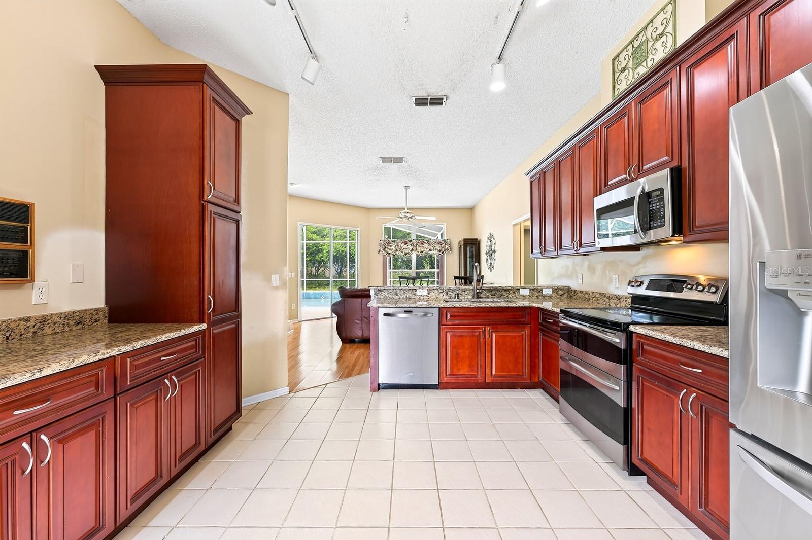 The Kitchen overlooks the Family Room and is ready for the home chef with NEW STAINLESS STEEL APPLIANCES, granite countertops, an abundance of wood ca