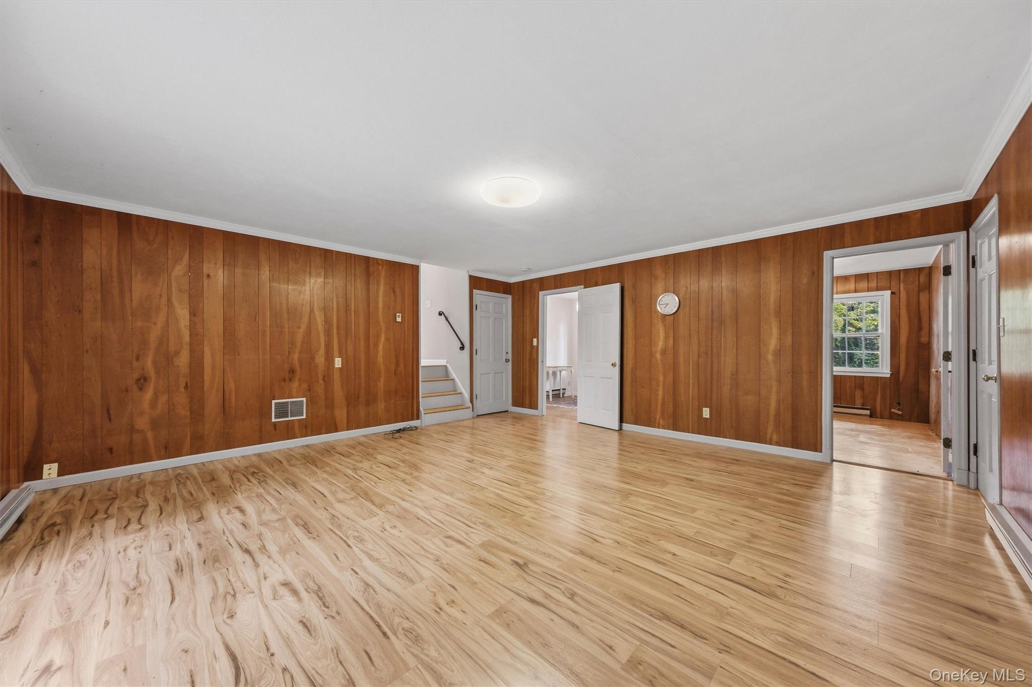 Enormous family room with new laminate floors and SGD to private backyard and patio