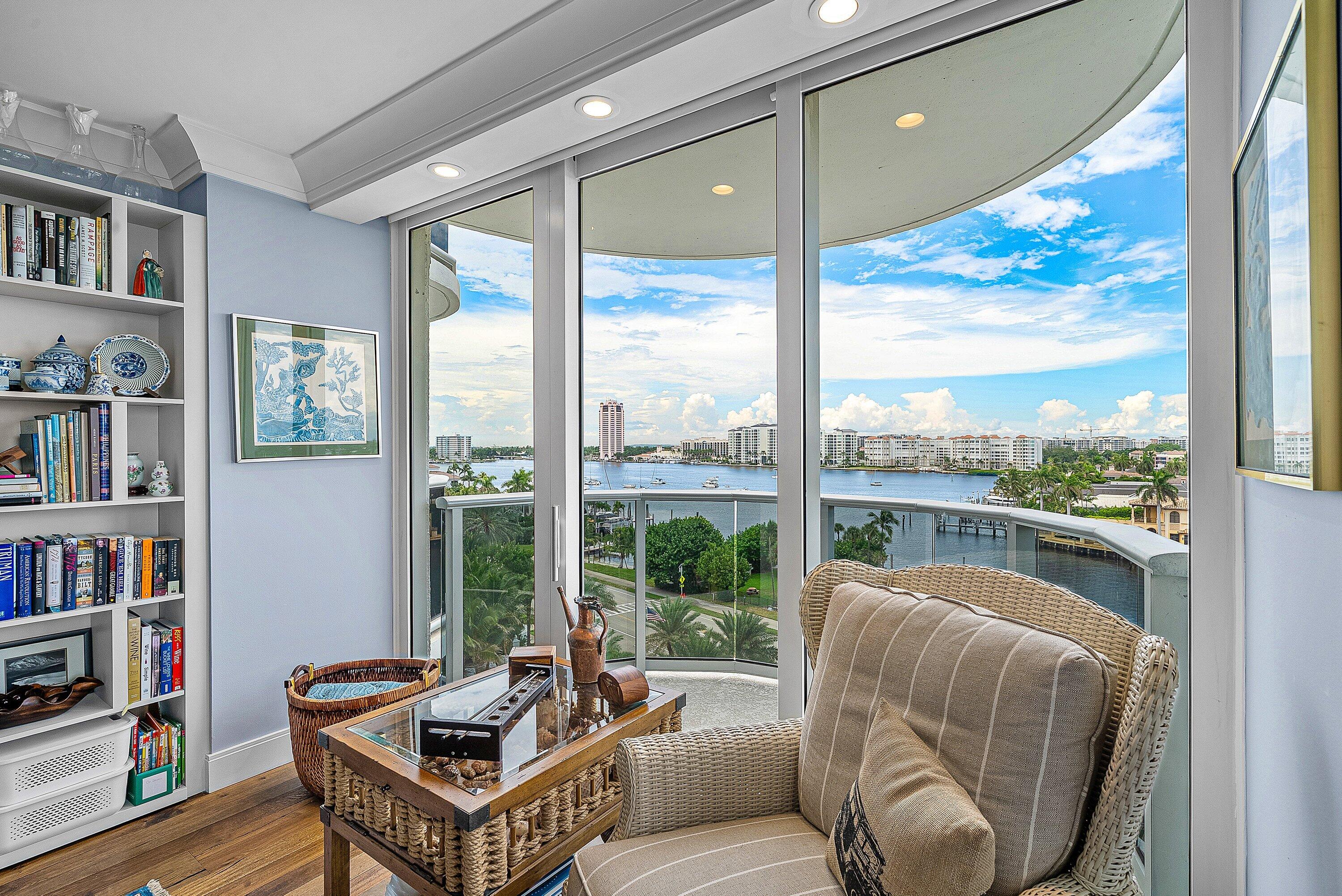 Floor-to-ceiling glass sliding doors, built-in shelving, crown molding, recessed lighting, and wood-finish flooring