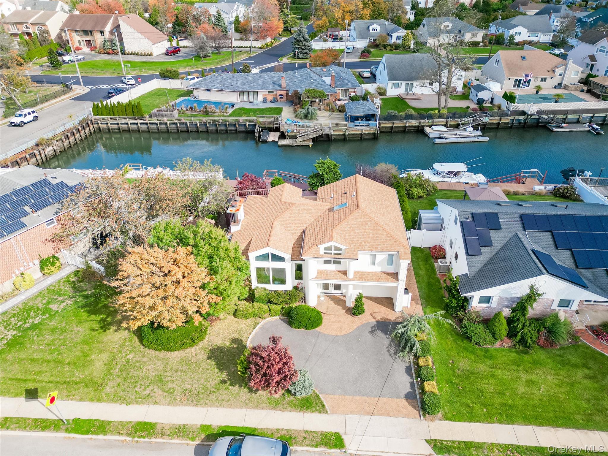 Aerial perspective of suburban area featuring a large body of water