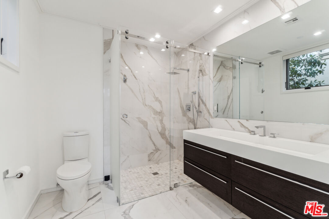 Bathroom with glass-enclosed s