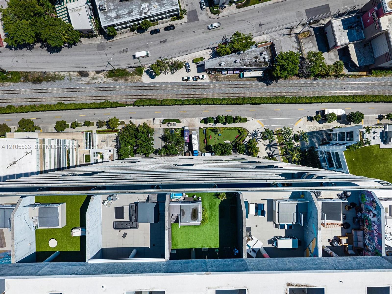 High-rise terrace featuring concrete dividers, synthetic grass surfacing, and private outdoor space