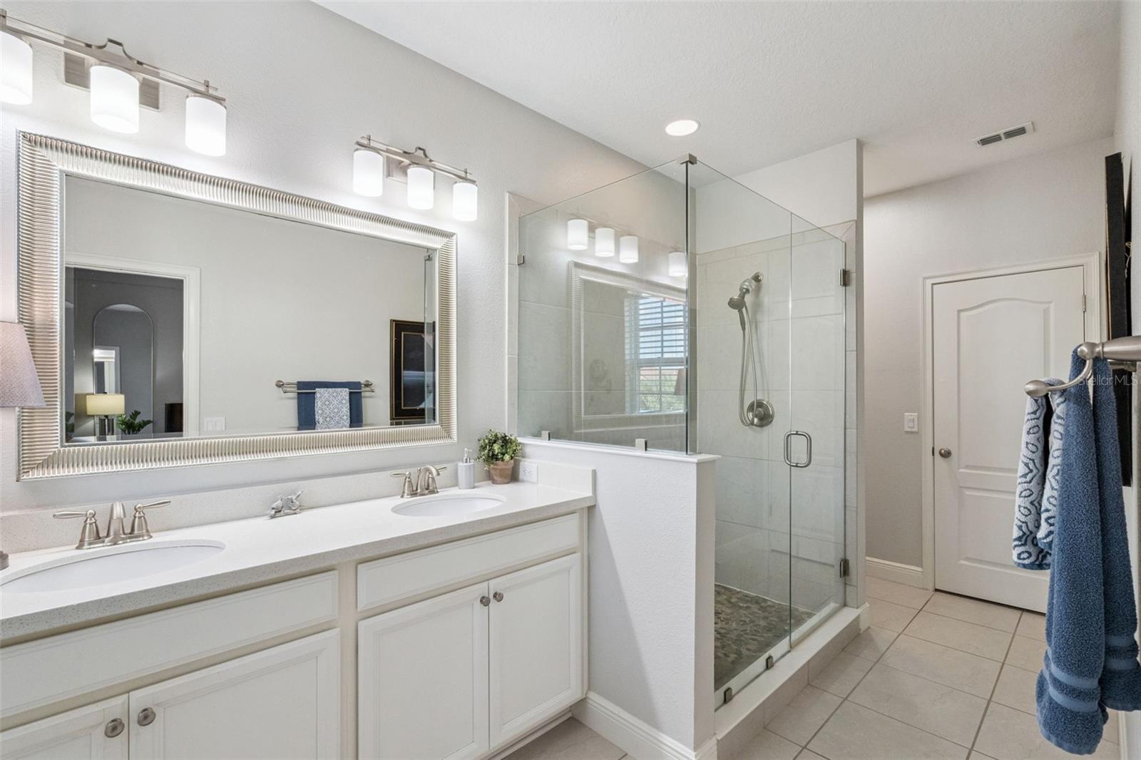 Primary bathroom through to walk in closet