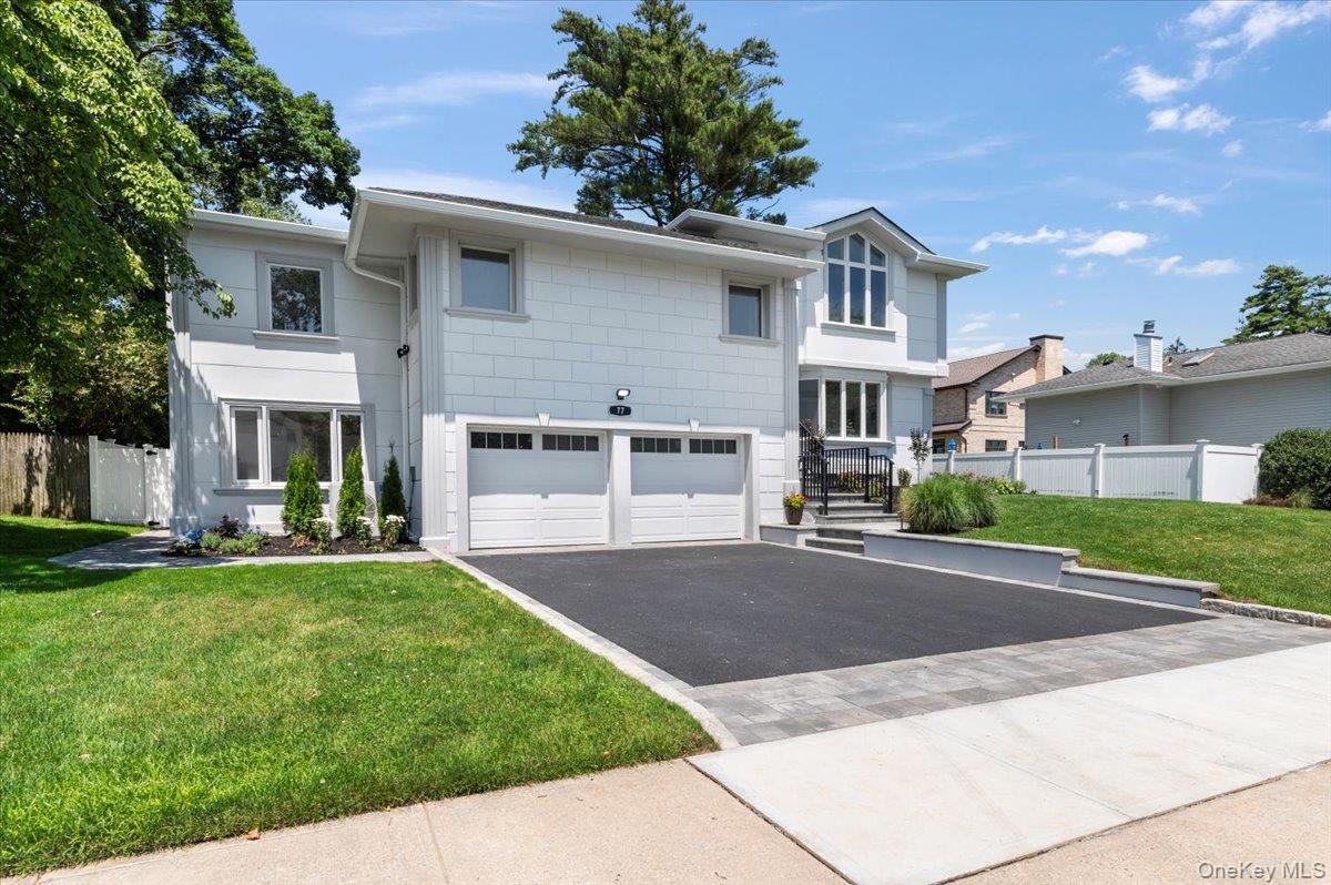 Modern home with asphalt driveway and a garage