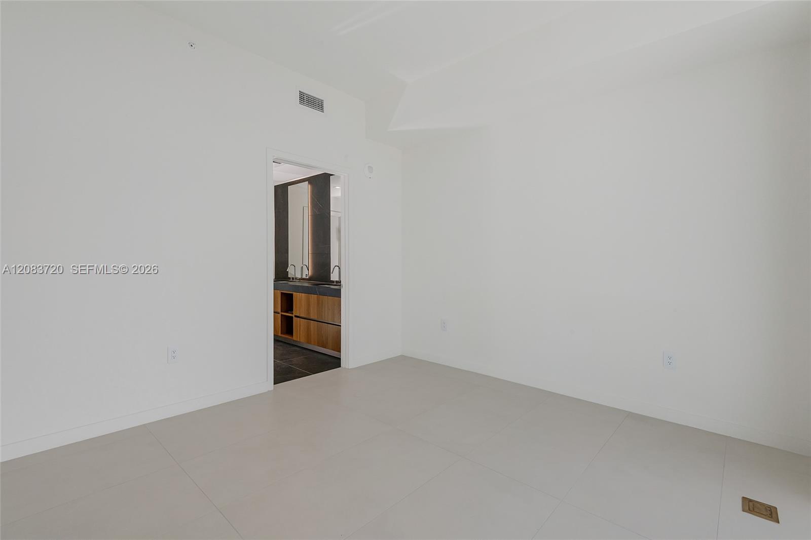 Neutral interior space featuring large-format tile flooring and smooth-finish walls