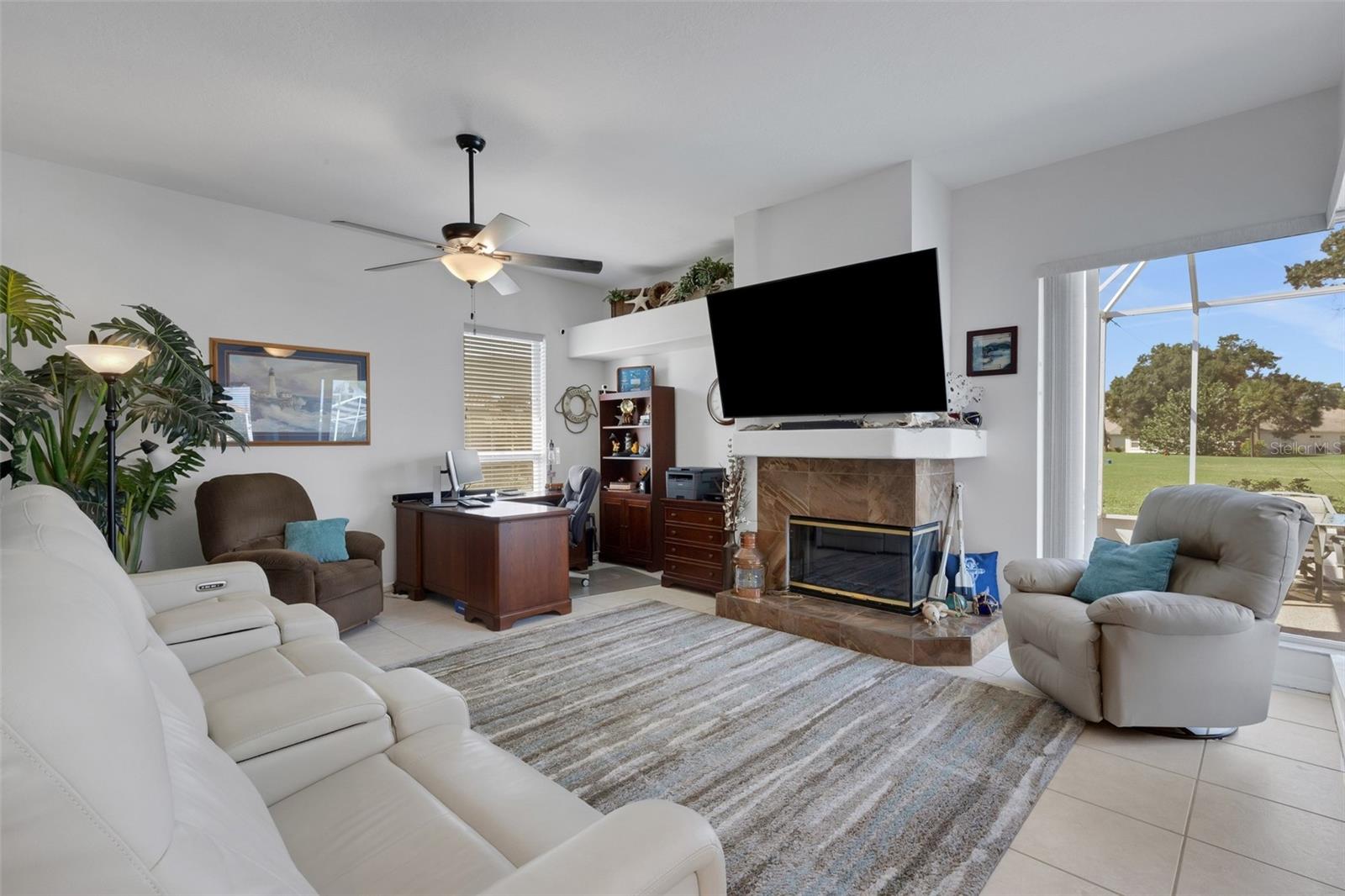 Family room with view of golf course and pool