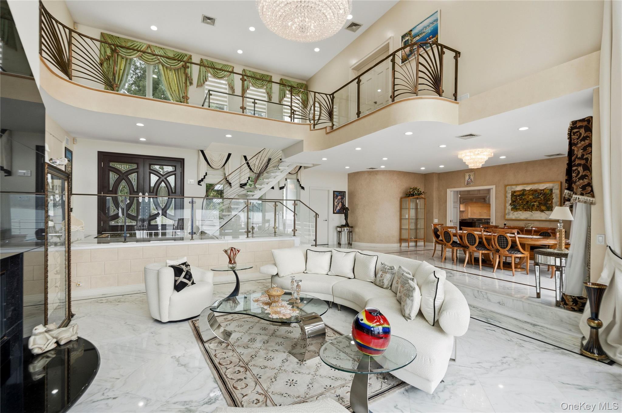 Great room, marble floating staircase, double door entry and custom railings