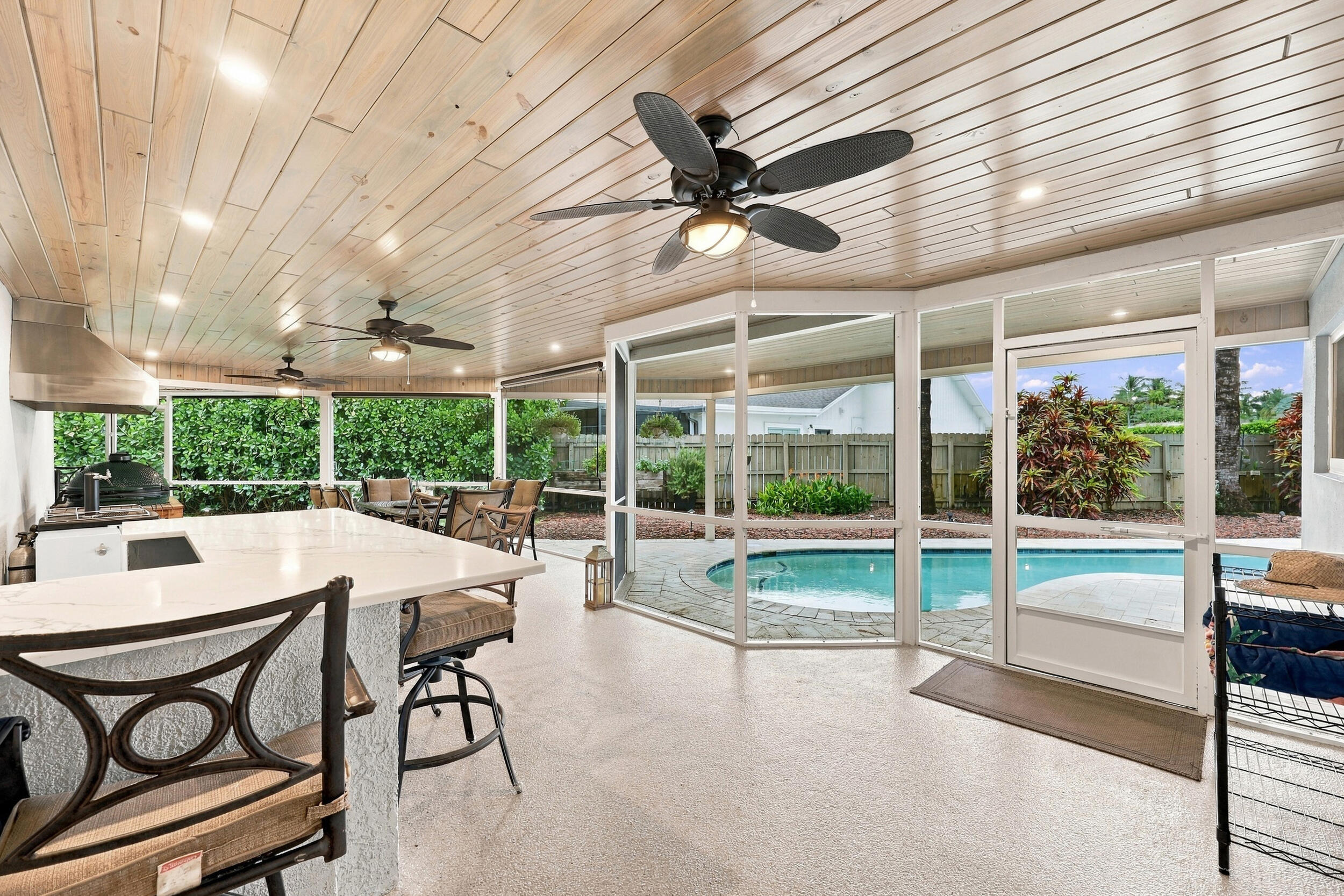 Live the epitome of the South Florida lifestyle with this 1,360 sq. ft. patio. It offers a built-in bar with quartz countertops, a grill area with hoo
