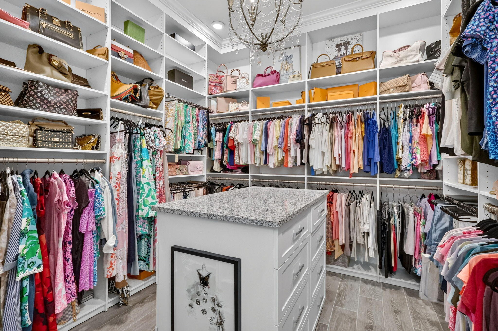 Custom Large Primary Closet #1 with 16 drawer island with stone top. high end cabinet pulls.