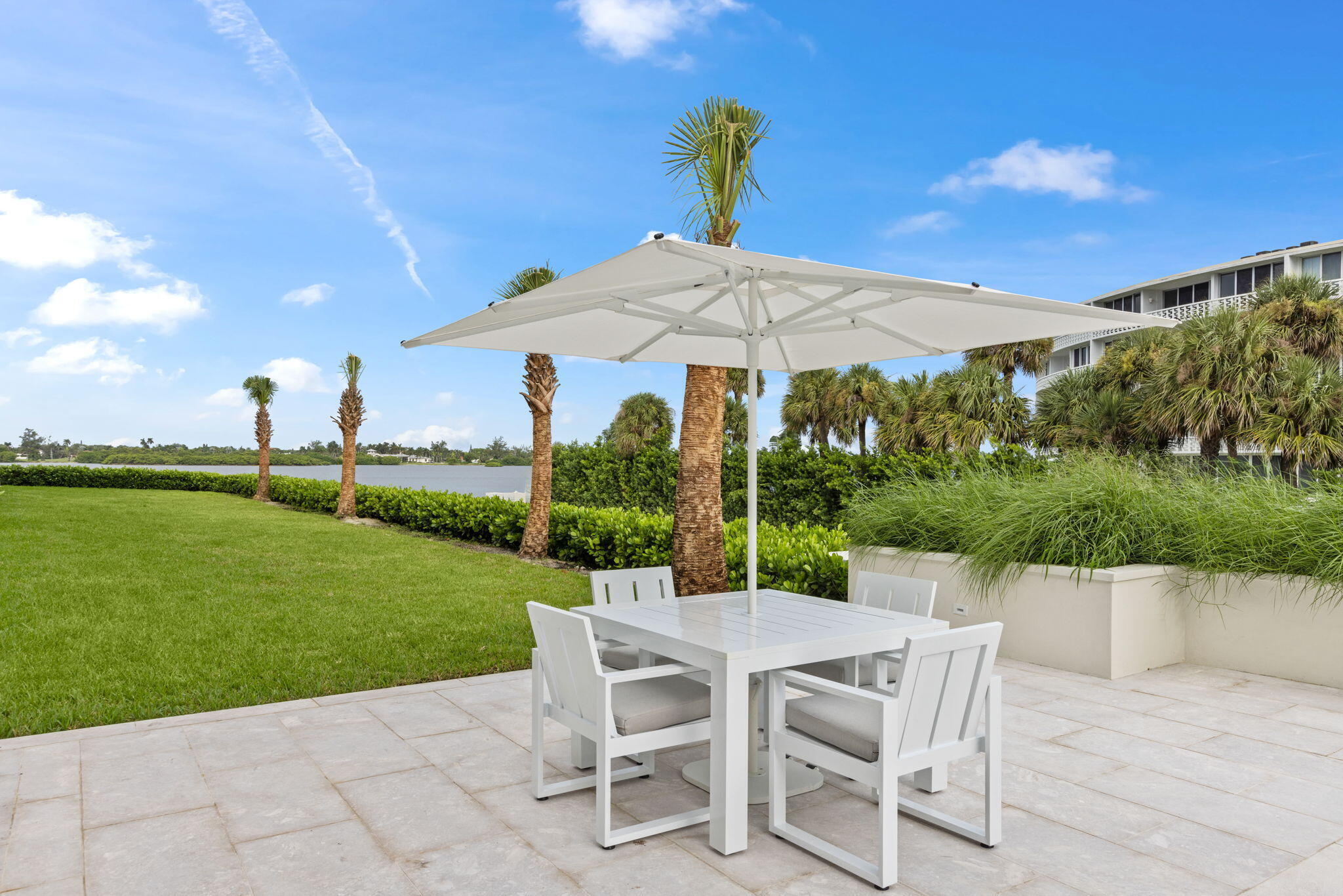 Expansive patio featuring a square umbrella and a rectangular table