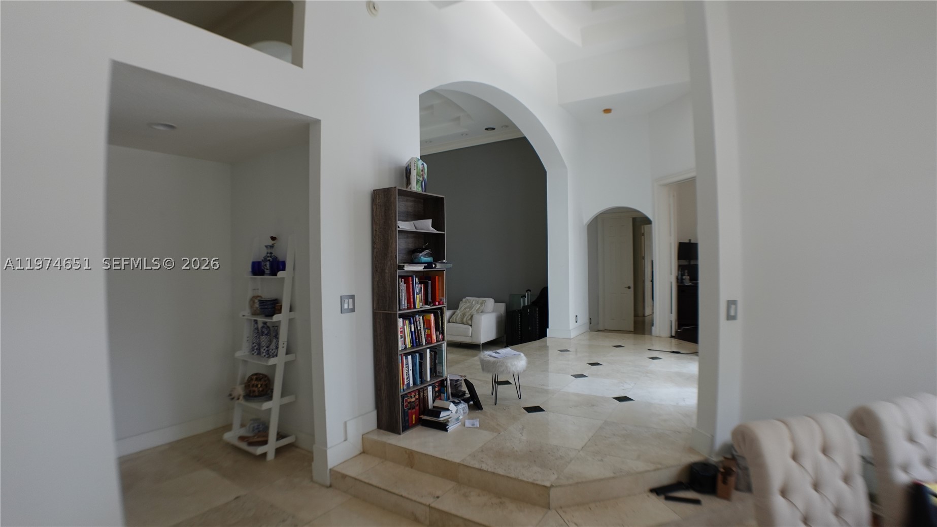 View from the Formal Dining Room towards the Kitchen (1st opening), formal Living Room and beyond to the office and Master Bedroom.