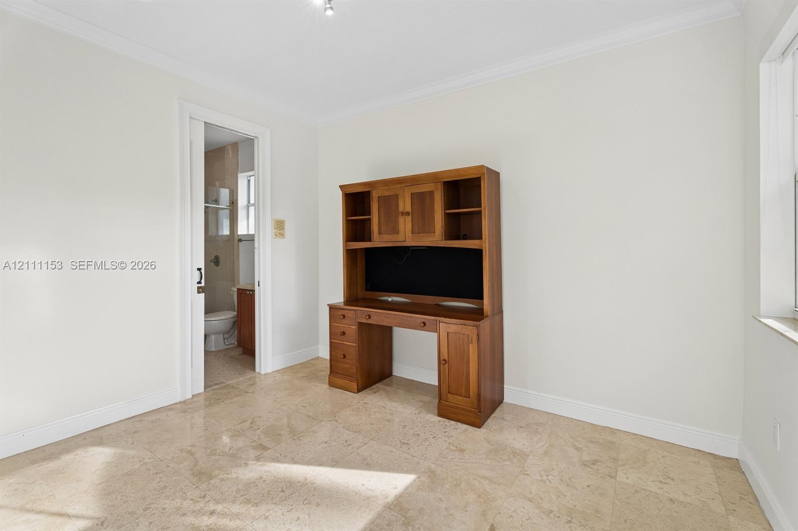 Stone-tile flooring, sliding door, and built-in wooden cabinetry
