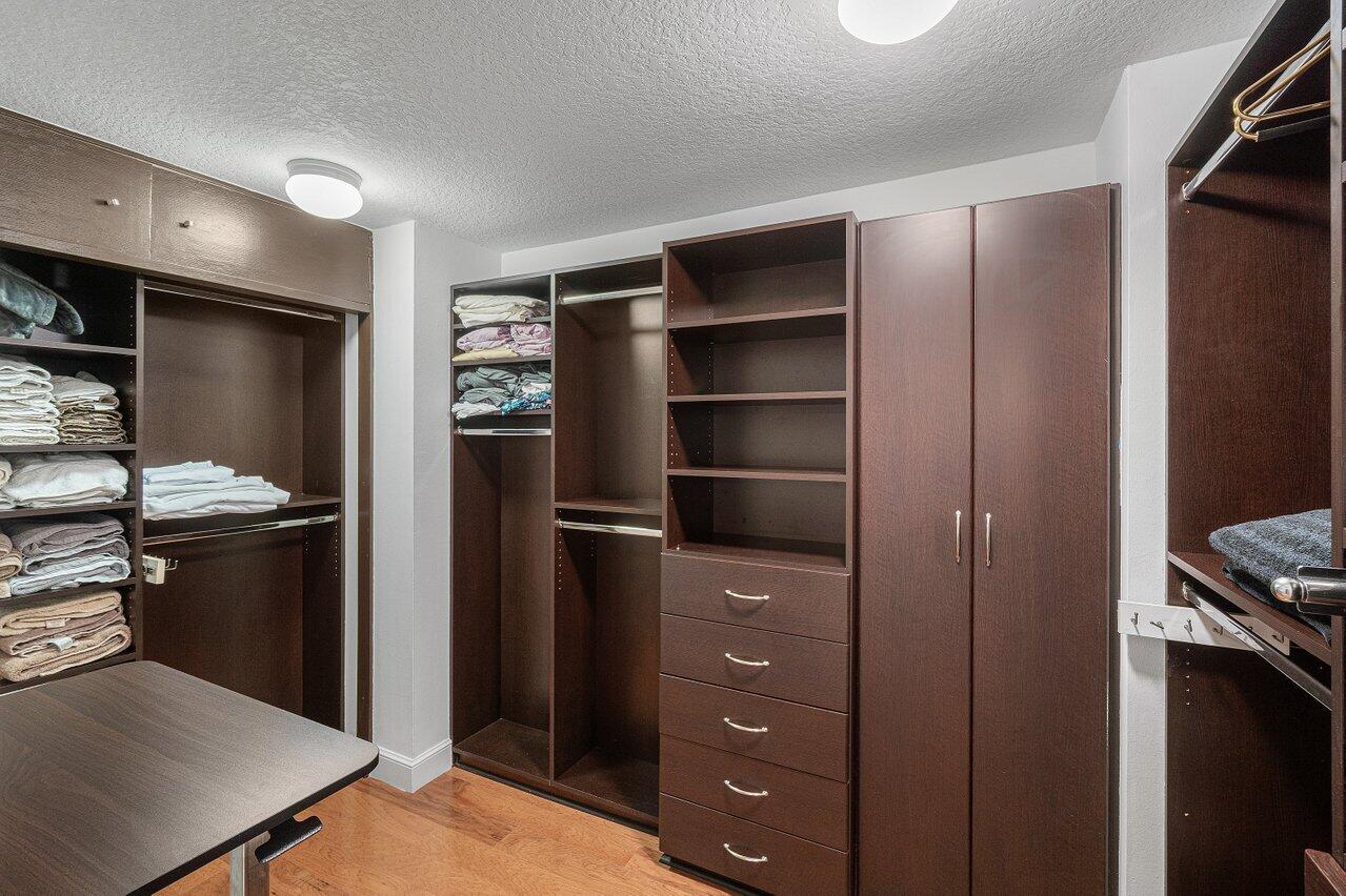 LARGE WALK IN CLOSET WITH CUSTOM CABINETS