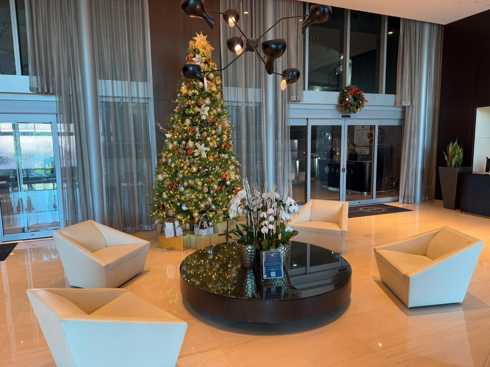 Spacious reception area with polished stone flooring and a contemporary chandelier