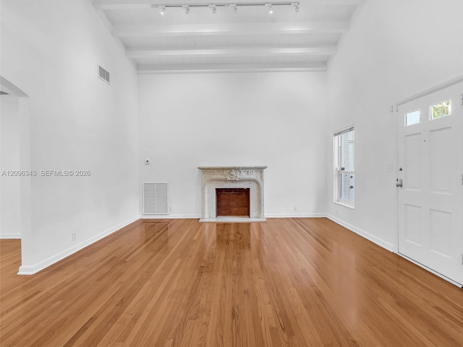 Awesome living room with high ceilings and exposed beams. Great home for rent in Coconut Grove in Miami, FL. Enjoy large fenced yard, updated home in 
