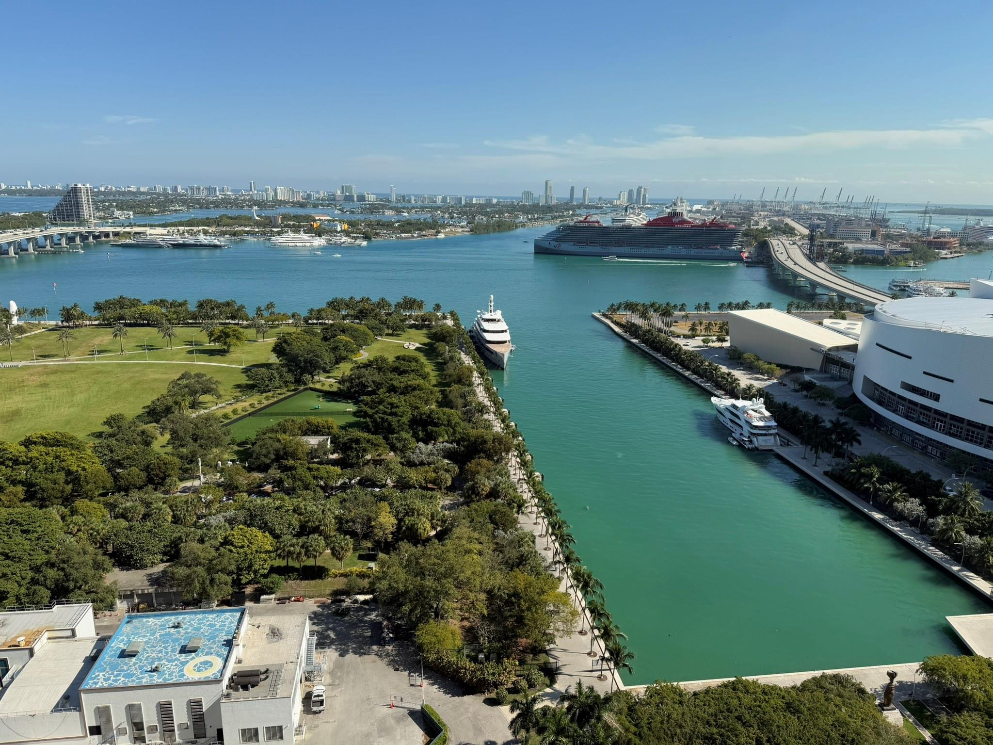 Aerial perspective featuring extensive waterways, a distant cityscape, and multiple bridges