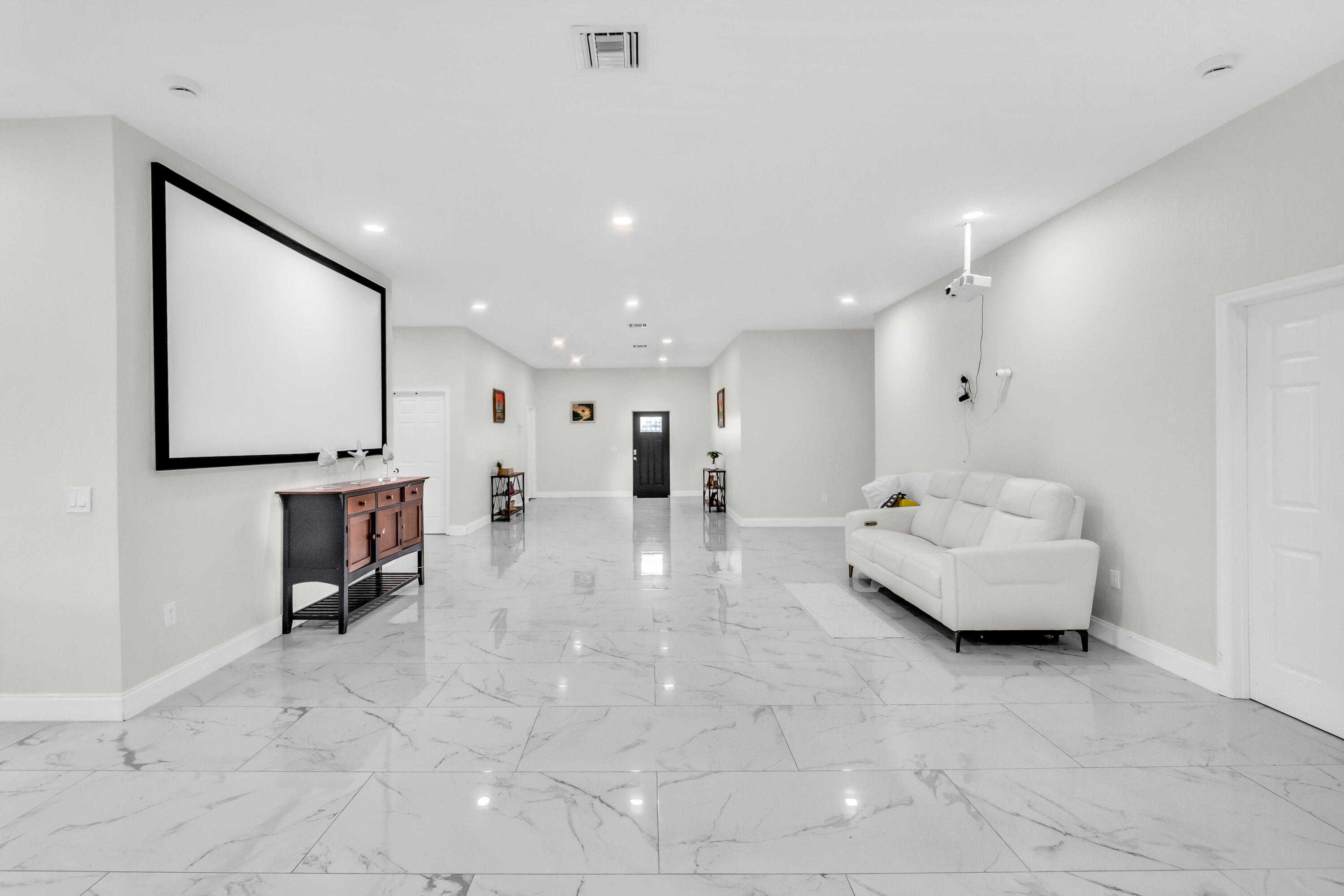 Spacious living area with 10-ft ceilings and recessed lighting