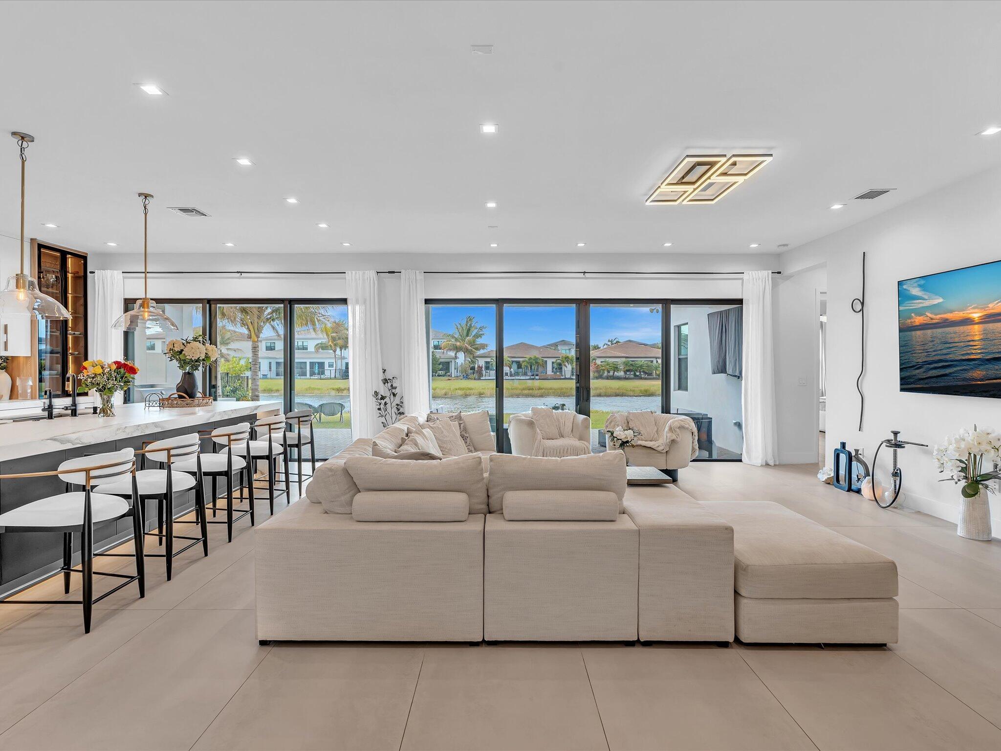 Spacious living area featuring clean modern finishes, recessed lighting, and seamless flow to the kitchen and dining spaces.