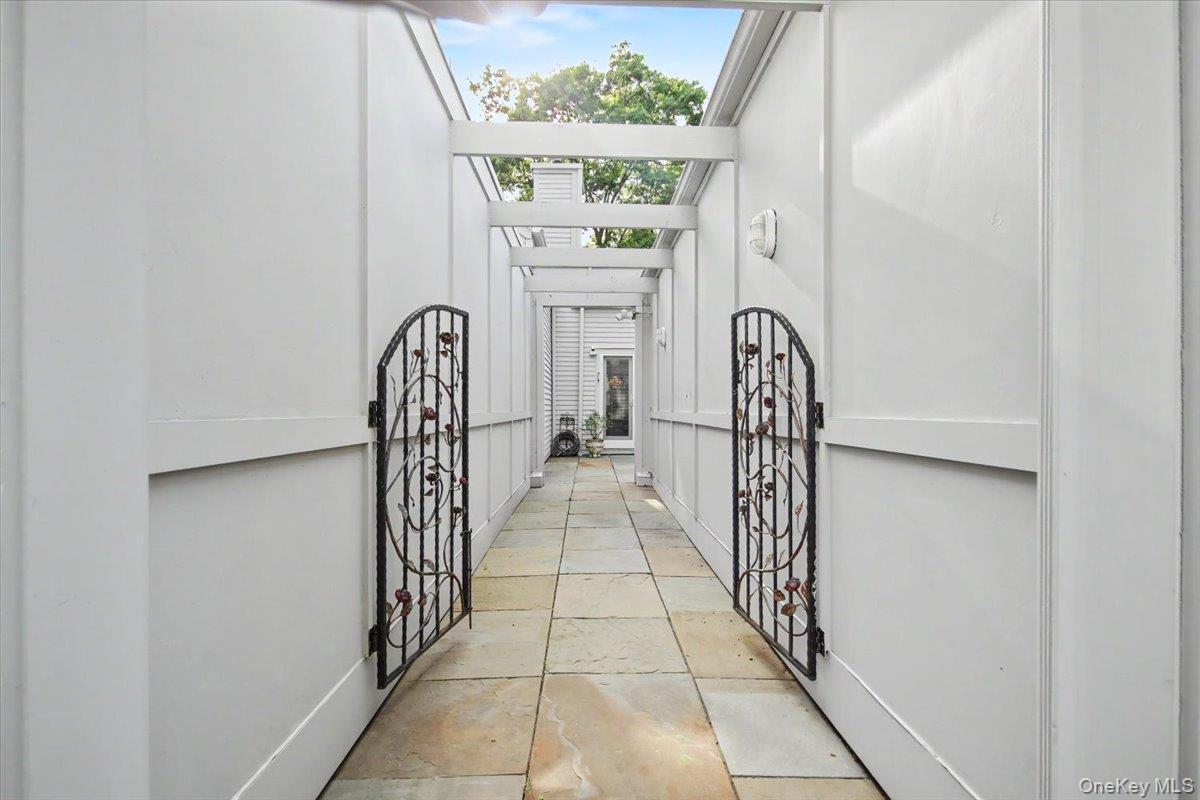 Path with decorative iron gate leading from driveway to your next home!