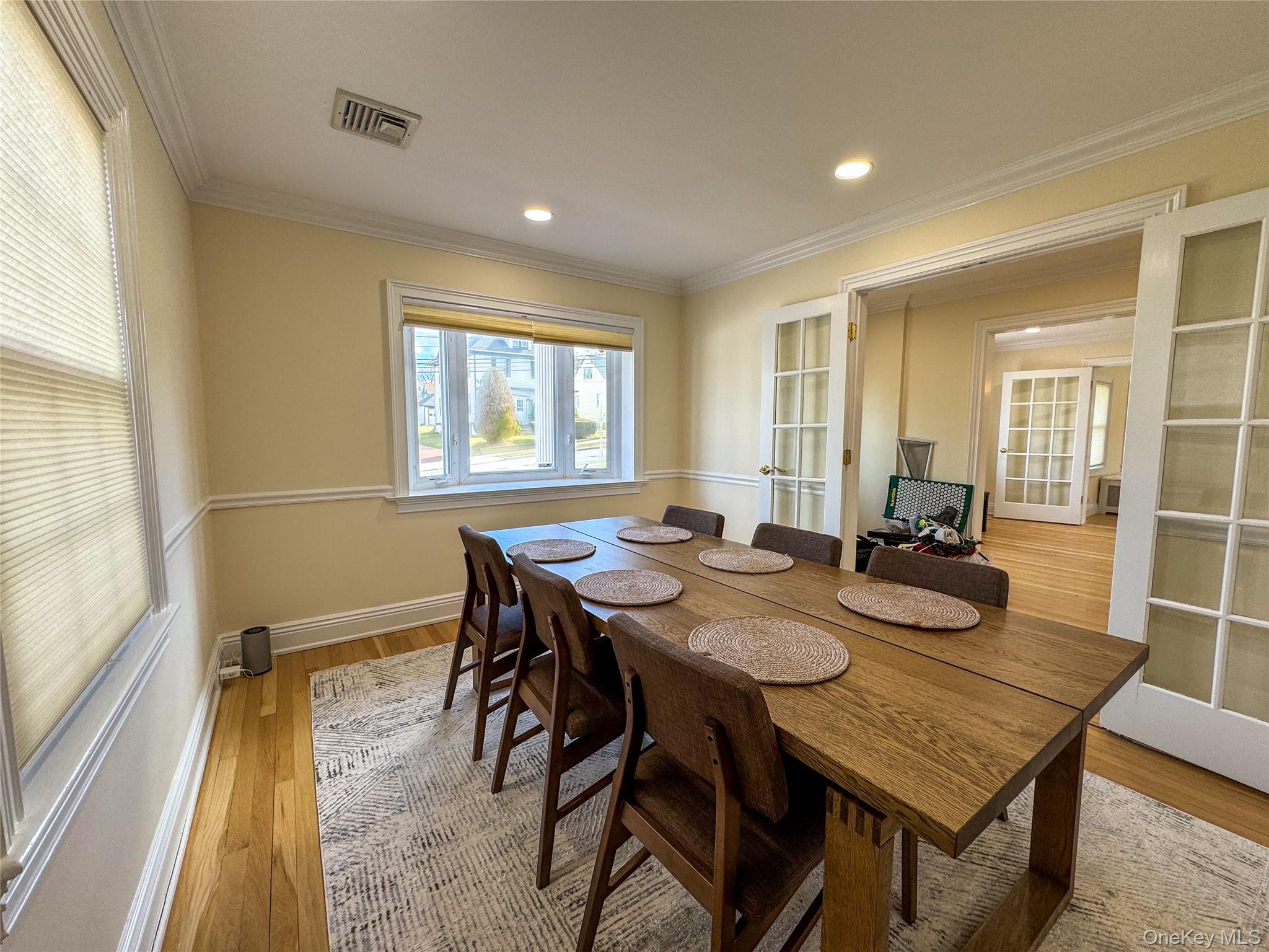 Hardwood flooring, recessed lighting, crown molding, chair rail molding, and French doors