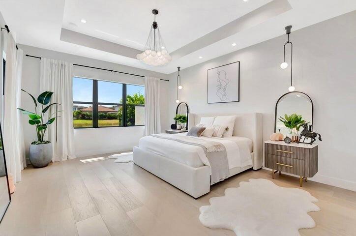 Spacious primary suite with tray ceiling detail, serene views, and a bright, airy layout designed for comfort.