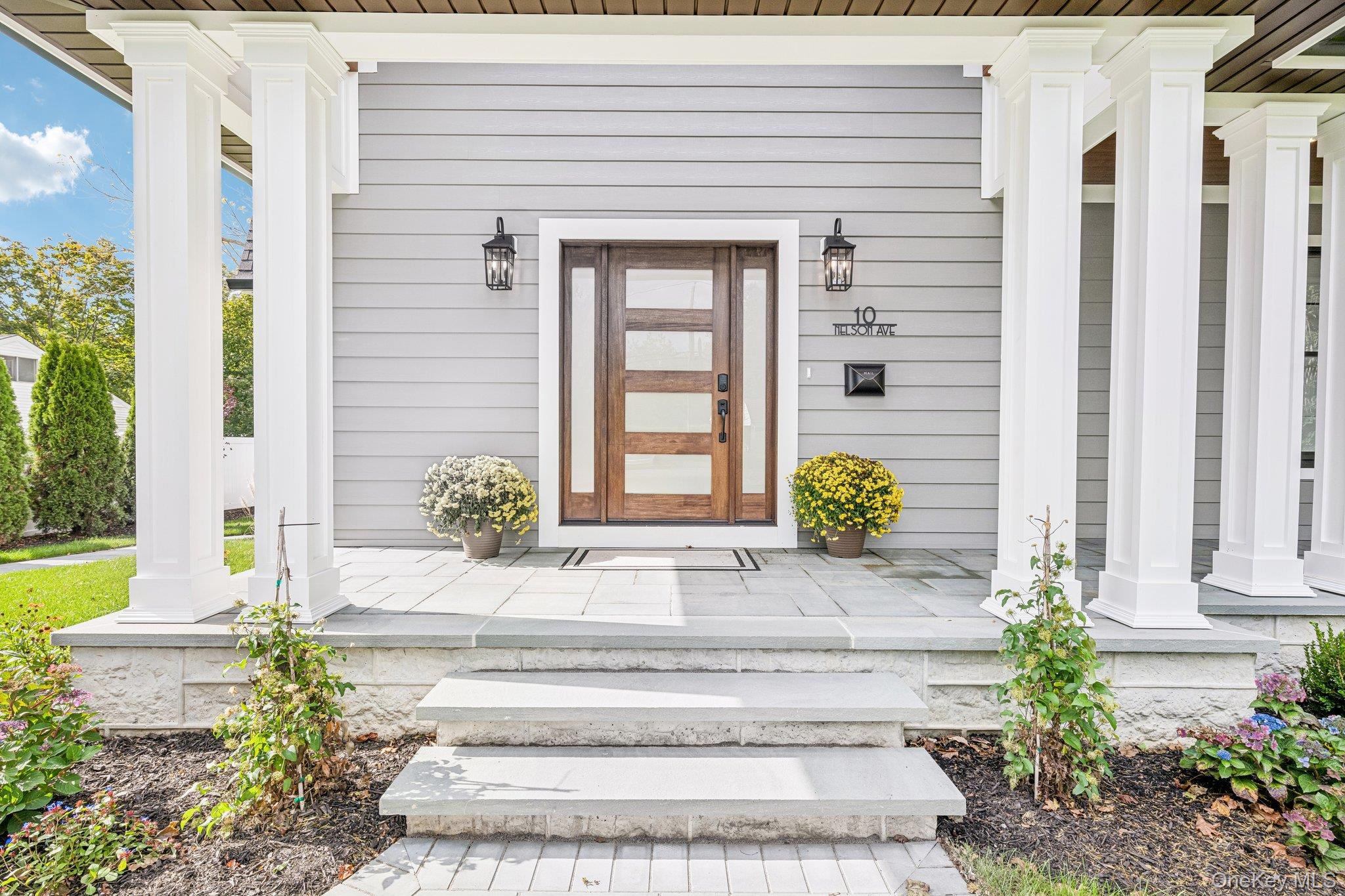 A columned front porch with stone steps, made for rocking chairs and hellos. Neighbors gather at Cavanaugh's on Blue Point Avenue, the local pub for n