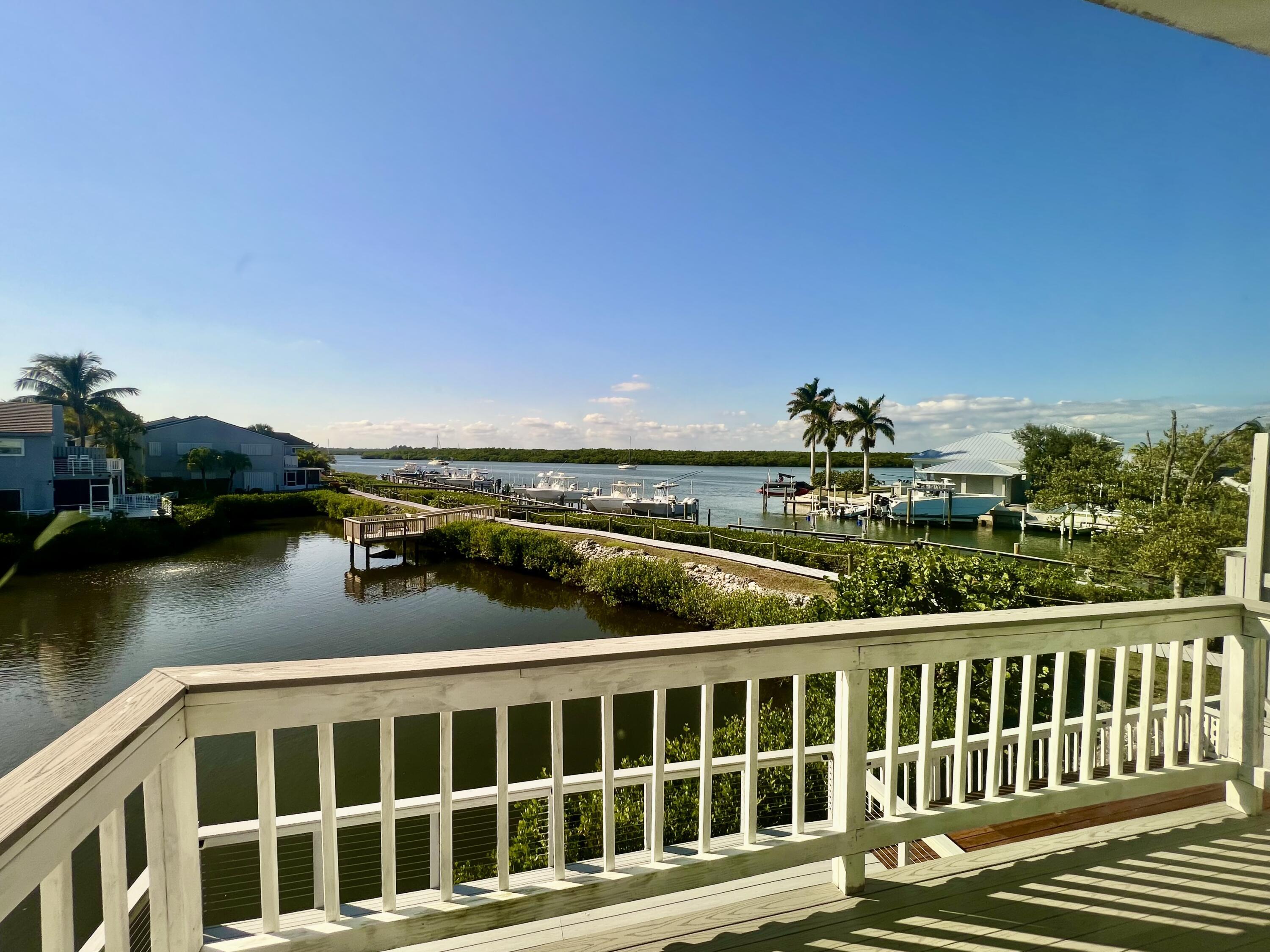 Waterfront property featuring a private deck with railing, direct water access, and boat dockage