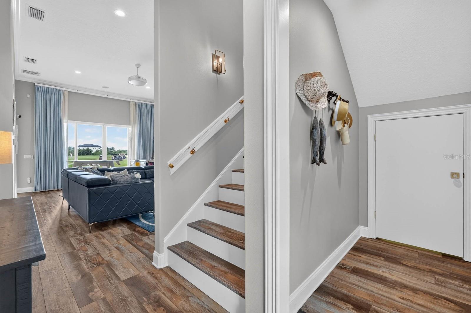 Entry downstairs into second living area with one guest room to your right and two to your left.