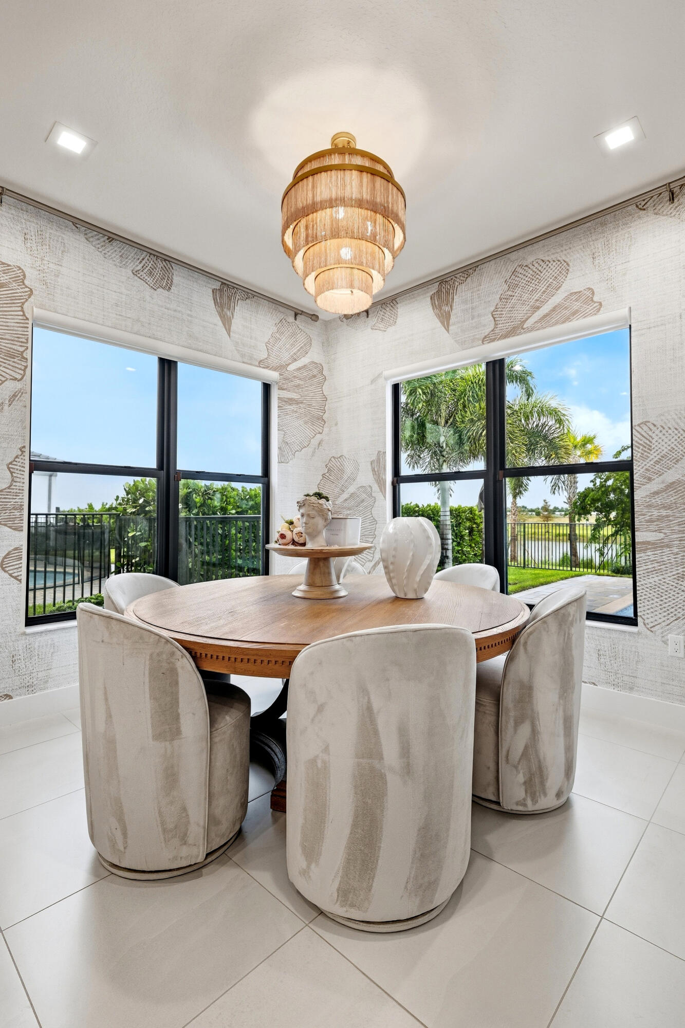 Bay windows with black frames, a tiered light fixture, and tile flooring