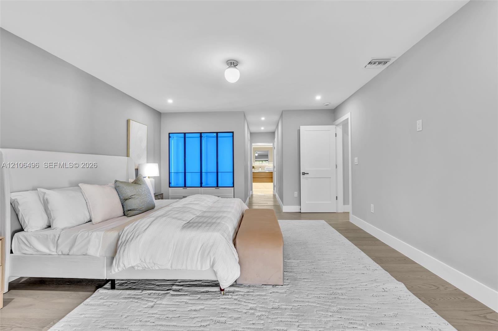 Neutral interior space featuring wood-finish flooring, recessed lighting, and a globe-style ceiling fixture