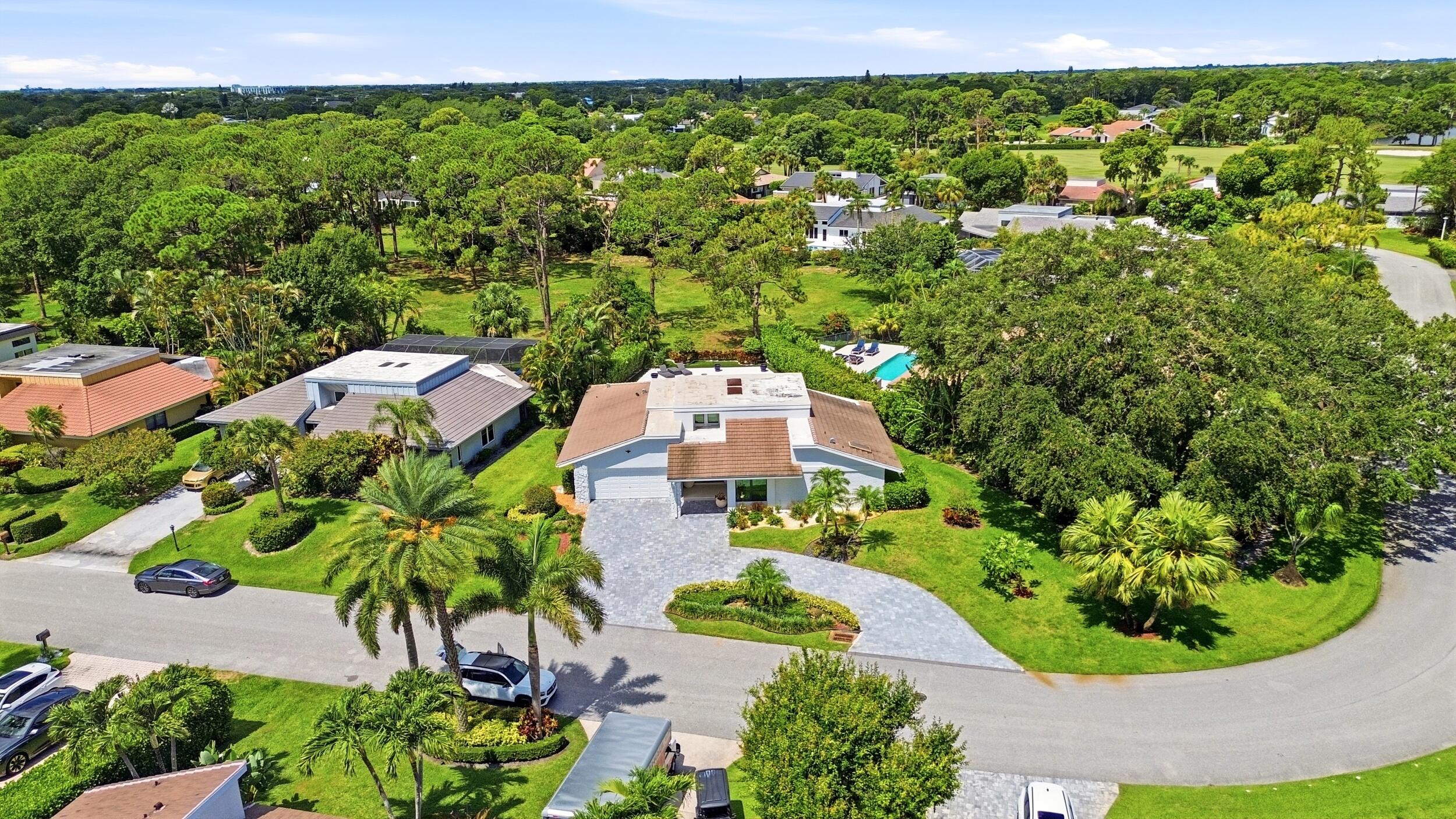 From above, the true rarity of this property comes into focus. Perfectly positioned on an oversized cul de sac lot, the home backs directly to a prote