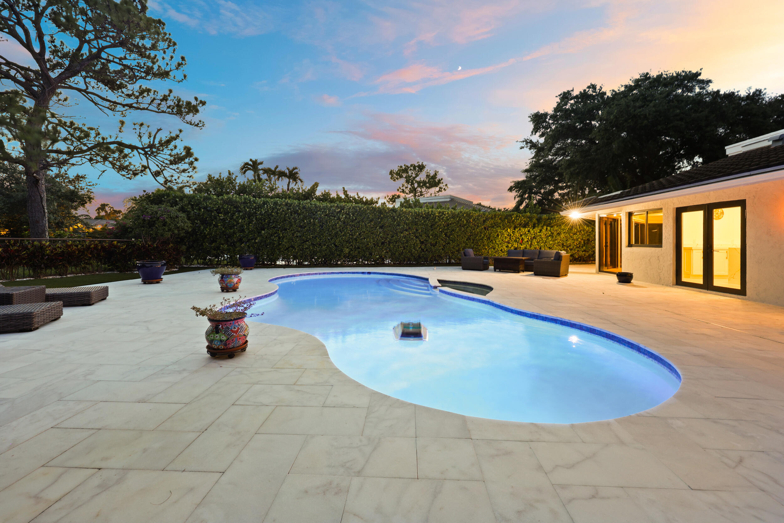 As the sun sets, this remarkable backyard transforms into a private evening retreat where luxury and nature exist in perfect harmony. Backing to a pro
