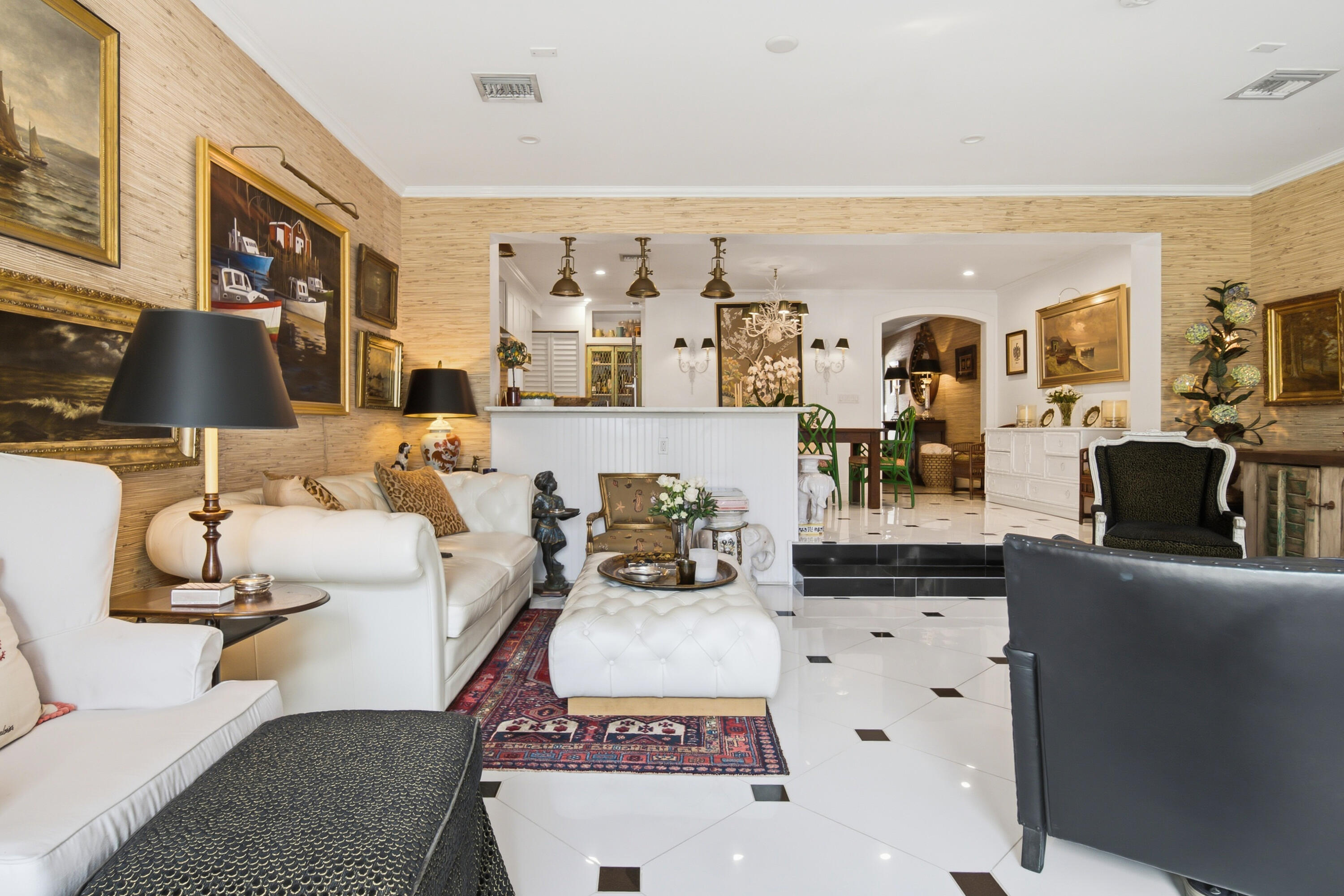 White and black square tiled flooring, textured wall coverings, recessed lighting, and a stepped threshold
