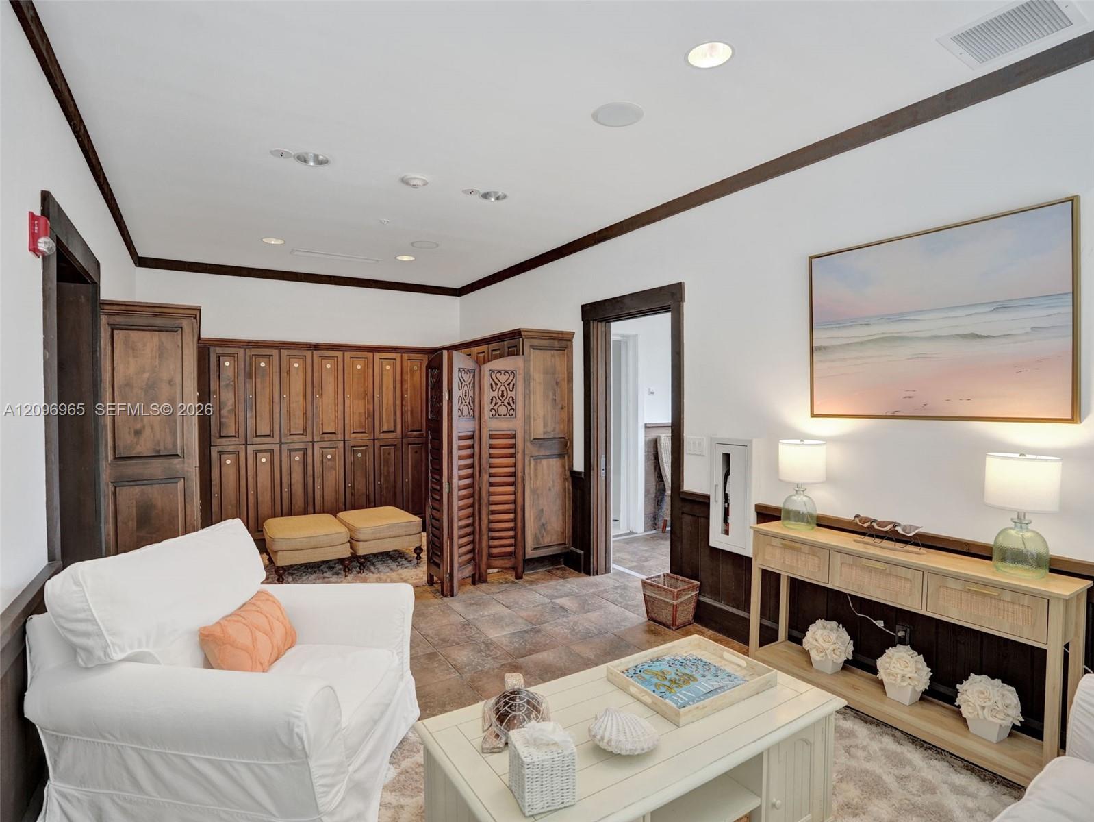 Custom wood-finish cabinetry, tile flooring, recessed lighting, and dark wood-finish trim throughout